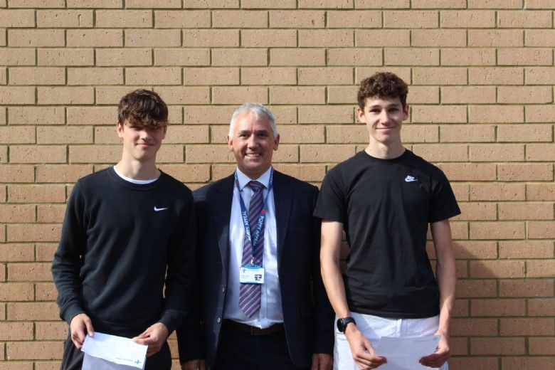Mr Frazer pictured with Harry (left) and Arthur (right). Both students achieved ten GCSEs graded between 7-9, seven of which were grade 9s.